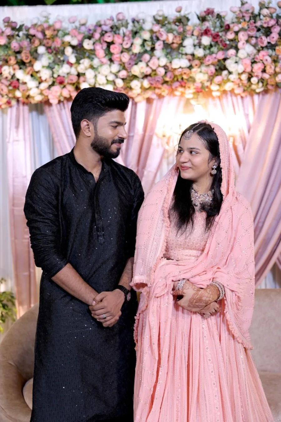 A couple smiling together at a floral celebration